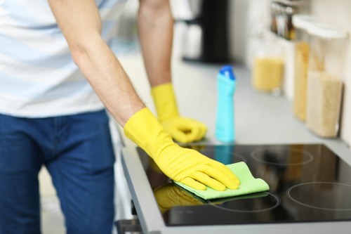 Safe and professional carpet cleaning team working in a tidy room