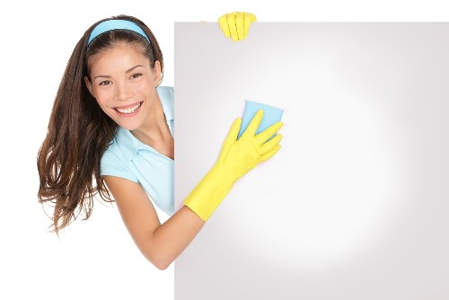 Cleaner treating a stained carpet with specialist equipment